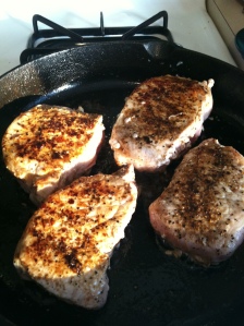 Pork chops in the skillet before the crushed pineapple bath.